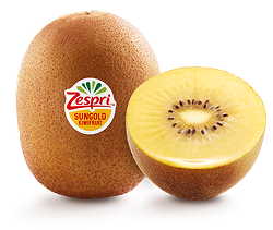 Un kiwi giallo intero e uno tagliato a metà